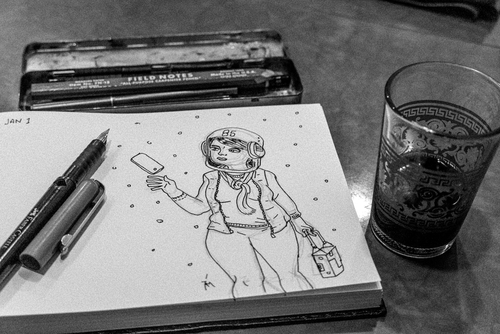 Photo of a sketchbook drawing of a space girl.