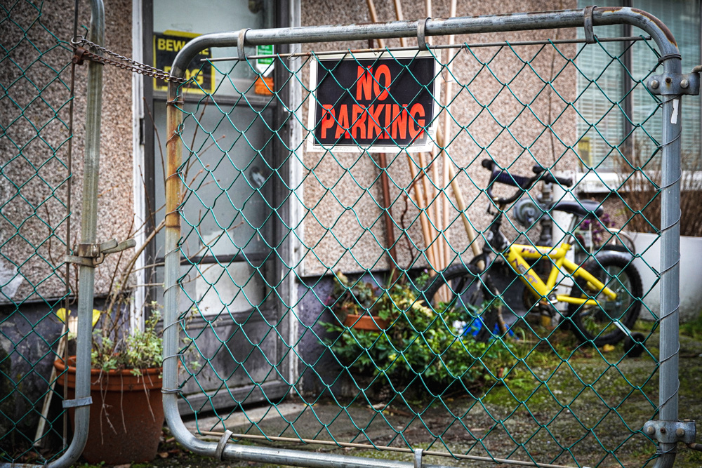 Photo of a No Parking sign on a fence.