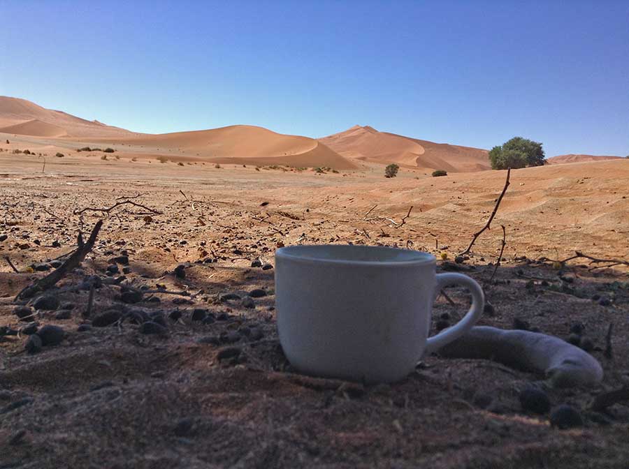 Photo of coffee cup taken in the sand dunes of Namibia.