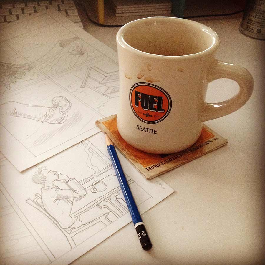 photo of coffee cup and my pencilled comic book pages.