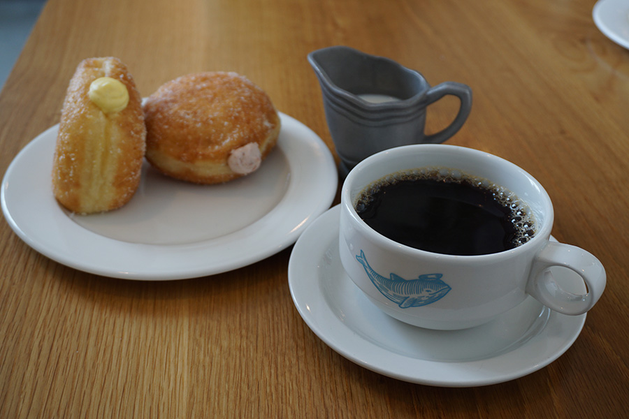 Photo of a coffee cup and custard filled doughnuts in Seattle.