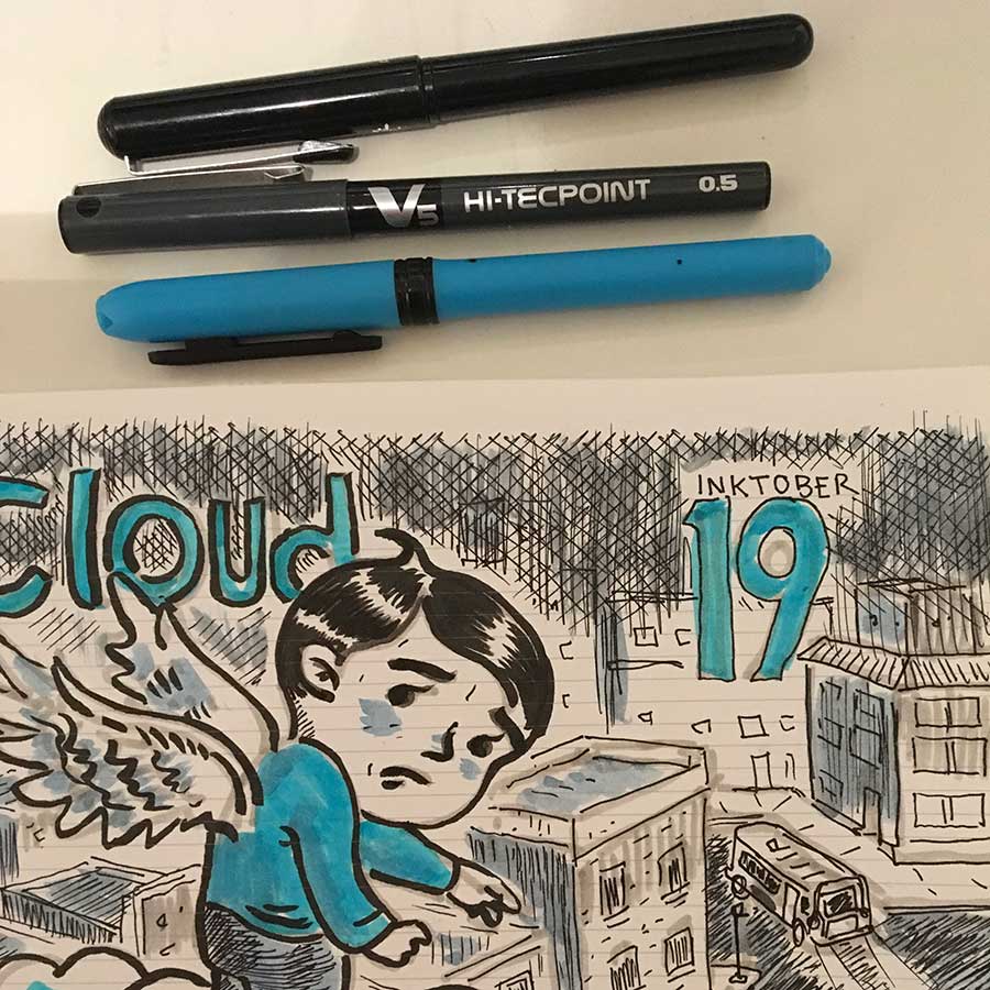 image of drawing pens and sketchbook.